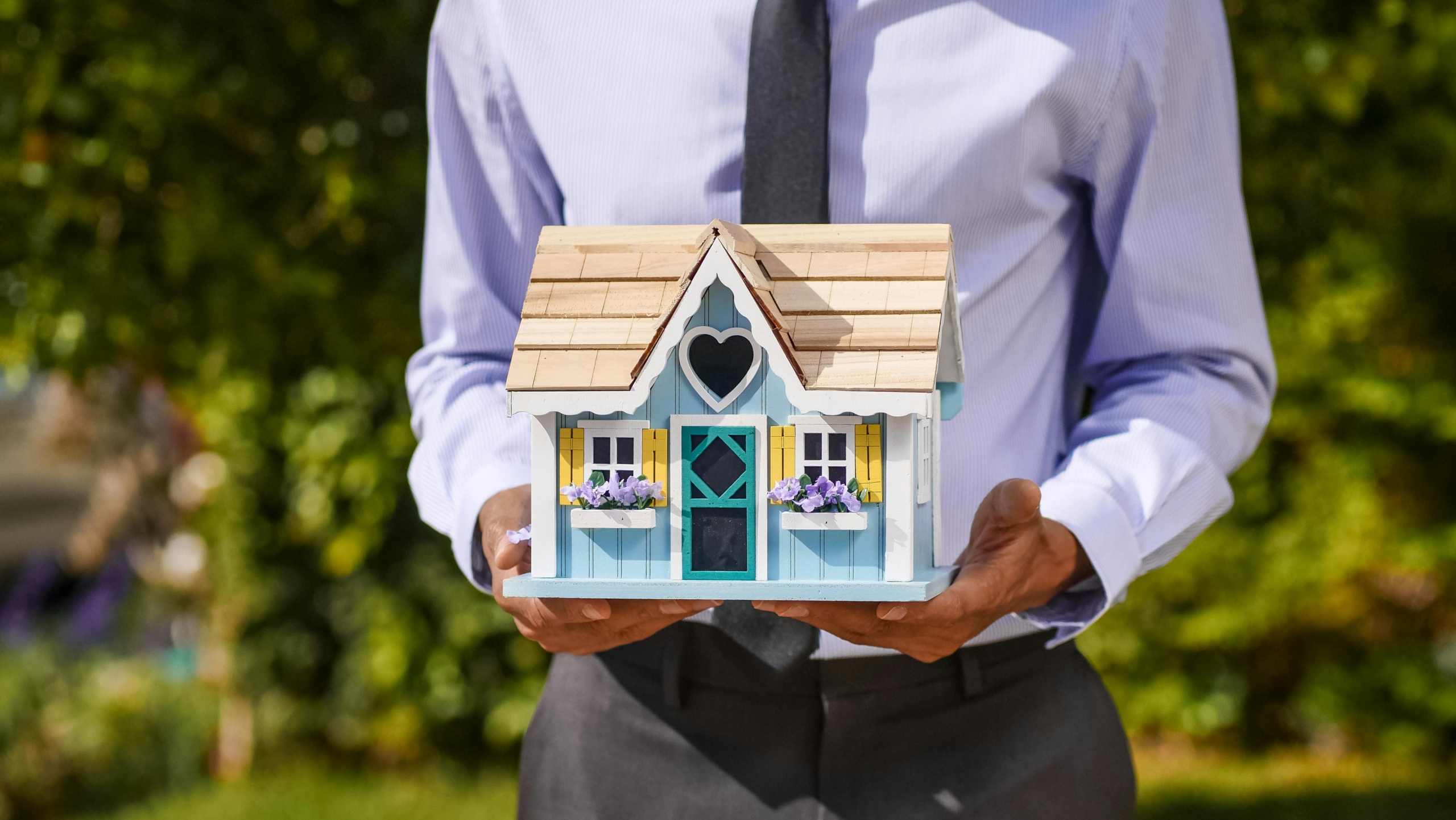 Property Manager holding a house model