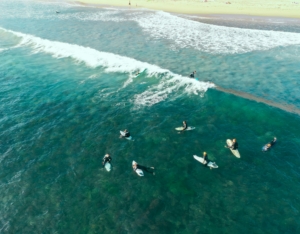 aerial shot of surfers in the ocean in San Diego, CA